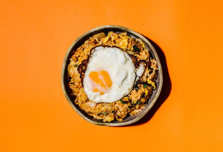 A bowl of kimchi fried rice with a fried egg on top